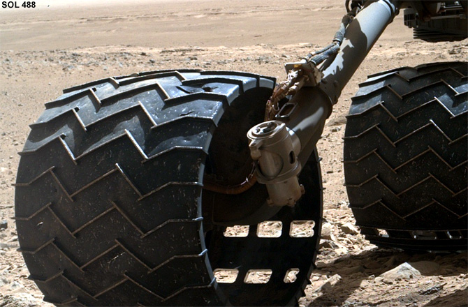 Curiosity's right-middle and rear wheels, bearing the scars of 488 sols of rough roving. Credit: NASA/JPL-Caltech